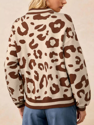 Chic leopard print knit sweater with brown animal print on a beige background, featuring a notched neckline and striped