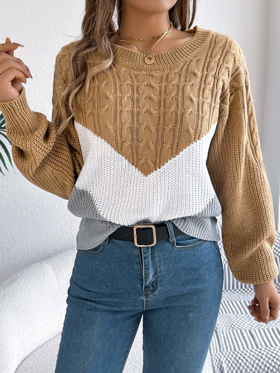 Chevron cable knit sweater in camel, white, and gray with crew neck.