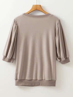 Mocha sweatshirt with gathered raglan puff sleeves and ribbed cuffs and hem.