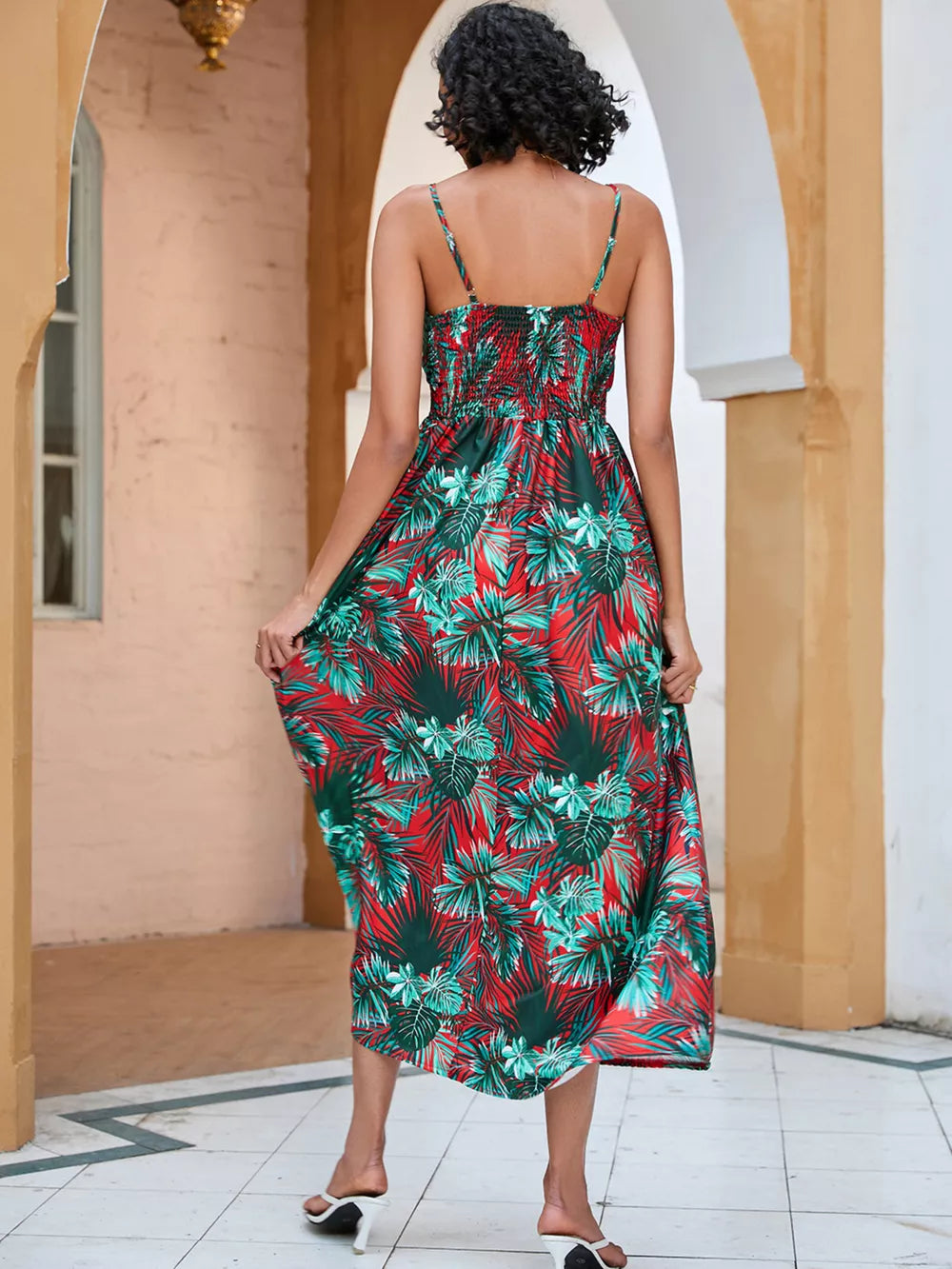 Chic floral midi dress with spaghetti straps in red and green tropical print.