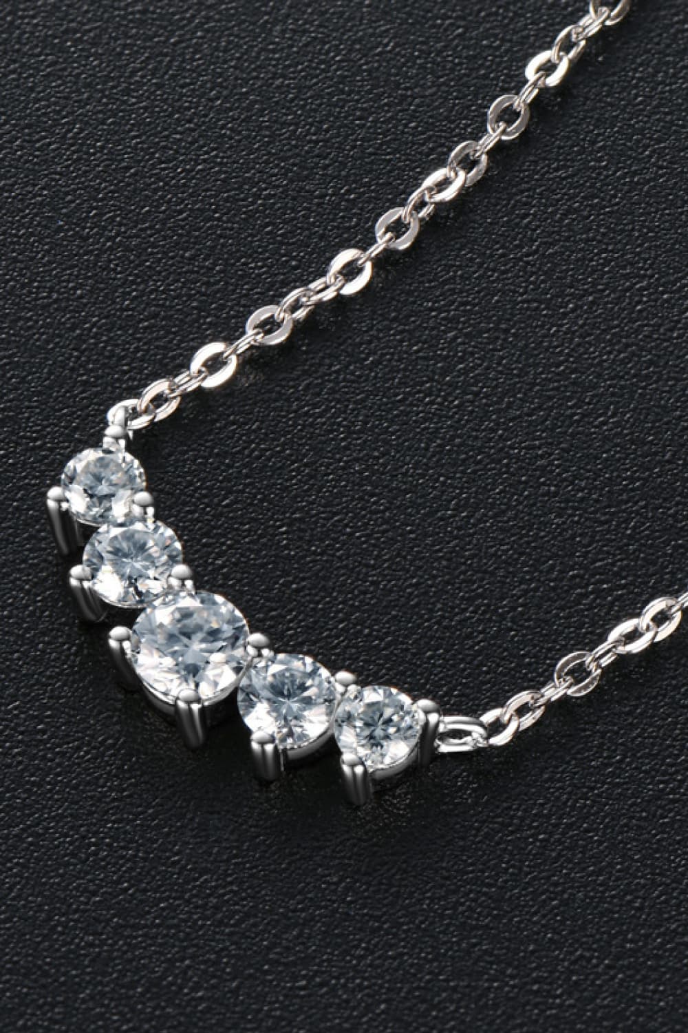Celestial Arc Necklace in silver with clear cubic zirconia stones on a delicate chain.
