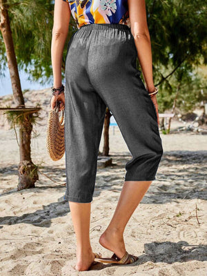 Dark gray cropped denim trousers with elastic waist and casual capri length.