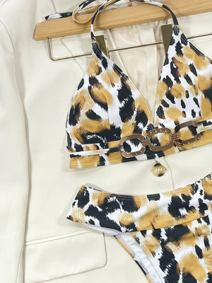 Leopard print bikini with gold chain detail on white blazer