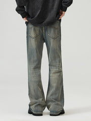 Vintage wash denim jeans with a wide-leg cut and distressed details.