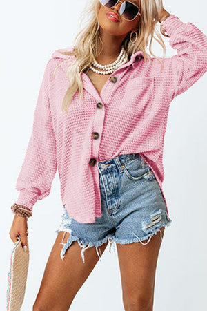 Blush pink waffle knit button-down shirt jacket with a collared neckline and button closure.