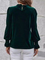 Dark green velvet blouse with blouson sleeves, ruffled neckline and cuffs.