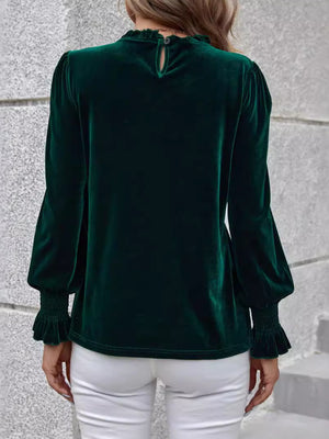 Dark green velvet blouse with blouson sleeves, ruffled neckline and cuffs.