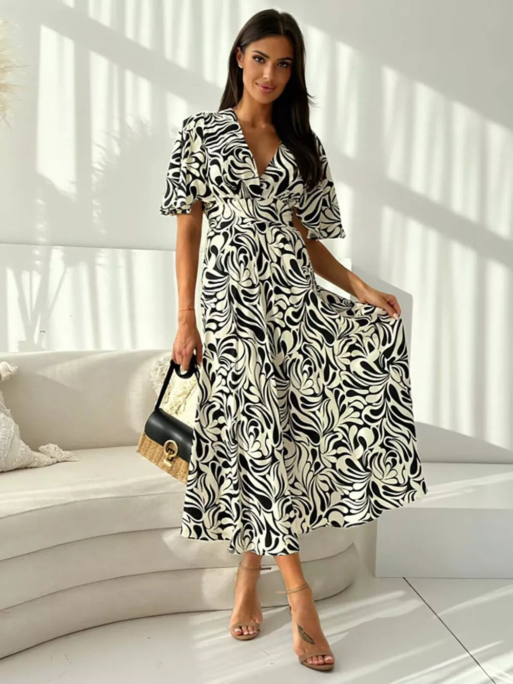 Vibrant abstract pattern midi dress with flutter sleeves and a-line skirt.