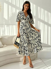 Vibrant abstract pattern midi dress with flutter sleeves and a-line skirt.