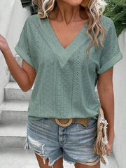 Sage eyelet V-neck tunic top with short sleeves and a relaxed fit.