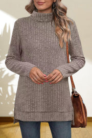 Ribbed knit turtleneck tunic top in Heather Gray with side slits, styled with jeans and a brown bag.