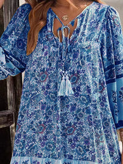 Light Blue floral print mini dress with tassel tie neckline and bell sleeves.