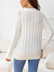 White cable-knit cardigan with ribbed texture and button front detail.