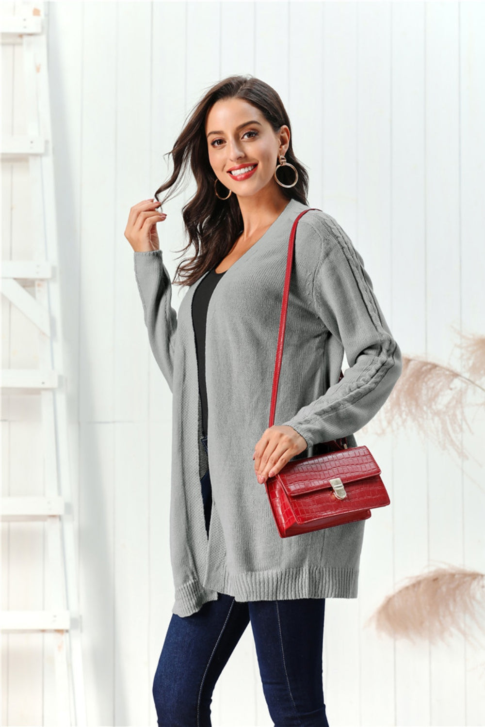 Gray cable knit open front cardigan with cable detail on sleeves.