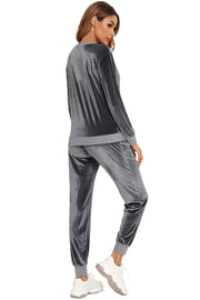 Velvet lounge set in charcoal with contrast trim on the waistband and cuffs.