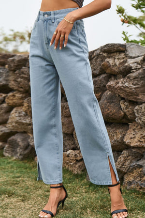 Light wash denim jeans with split hems and straight legs.