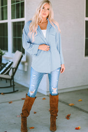 Light blue textured stripe oversized fit overshirt with button front and chest pocket.