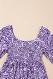 Paisley print smocked bodice blouse in lavender with square neckline and puff sleeves.