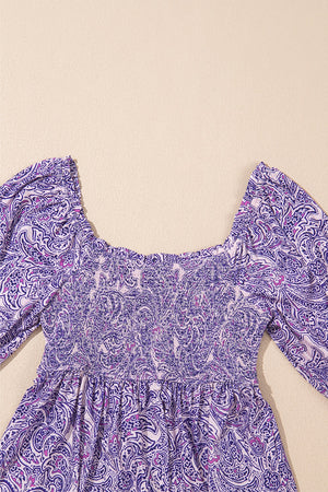 Paisley print smocked bodice blouse in lavender with square neckline and puff sleeves.