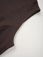Chocolate cropped vest detail showing seam and fabric texture.