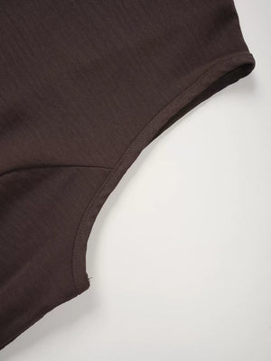 Chocolate cropped vest detail showing seam and fabric texture.