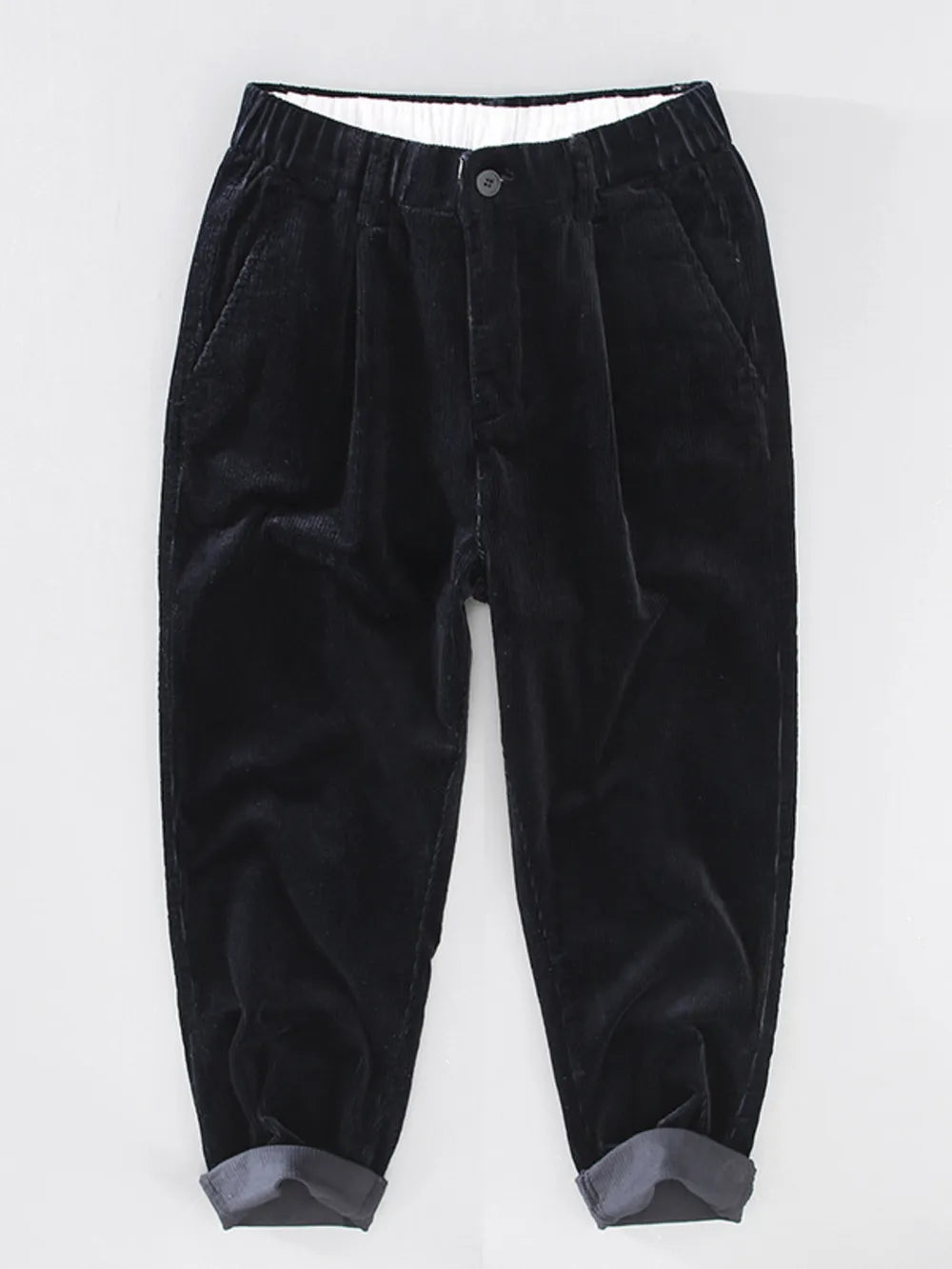 Black corduroy pleated pants with elastic waistband and cuffed hem