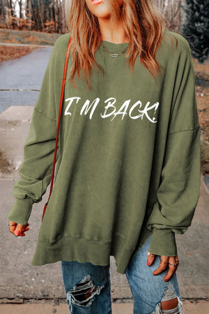 Moss green oversized slouch sweatshirt with white I'm Back! graphic, crew neck, and long sleeves.