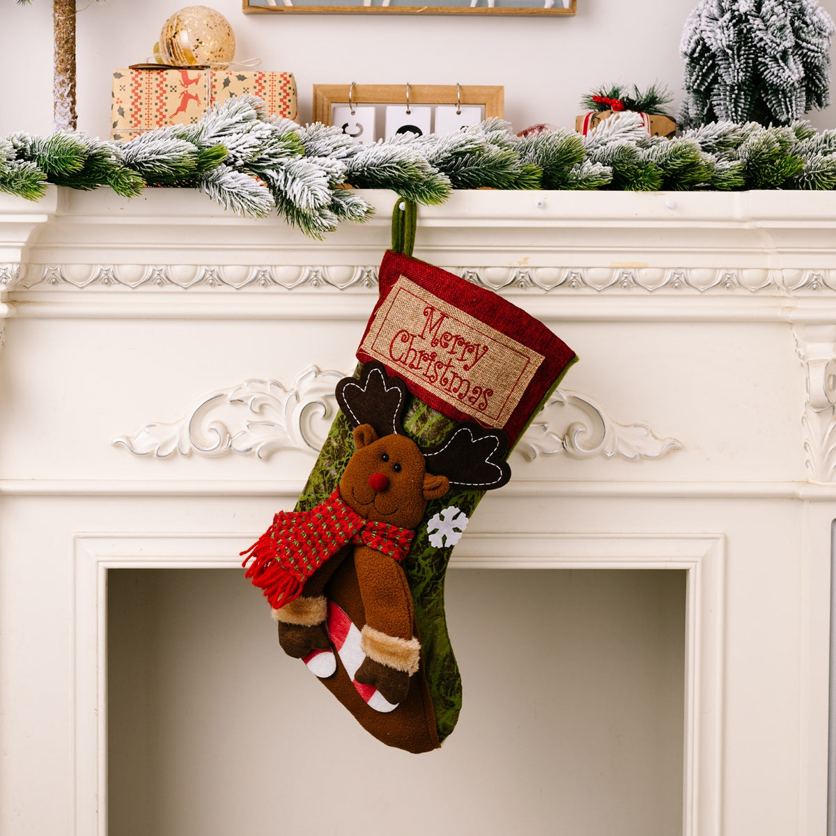 Embroidered Christmas stocking with reindeer, red scarf, and Merry Christmas patch.