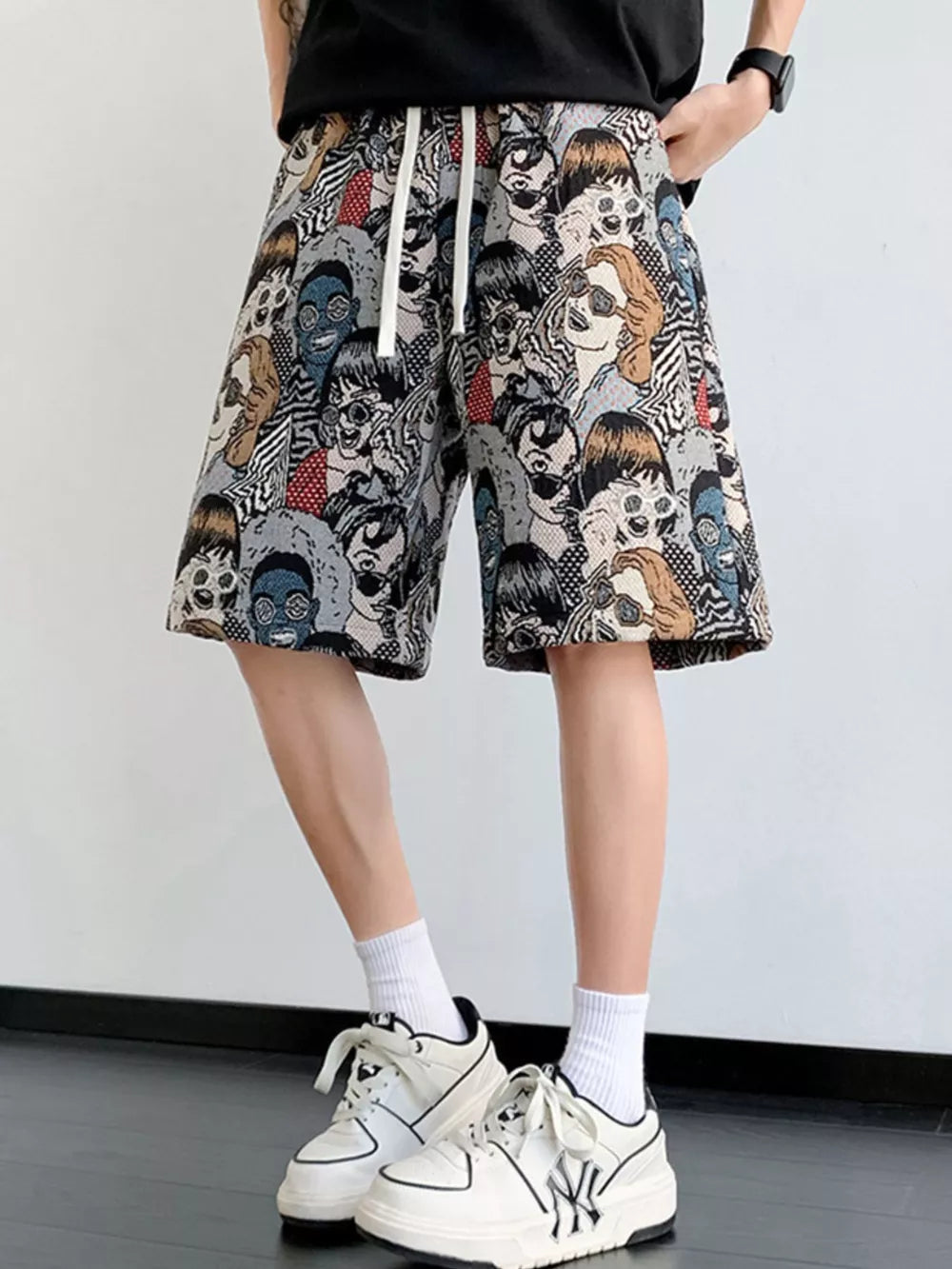 Chino shorts with all-over face print and drawstring waist.