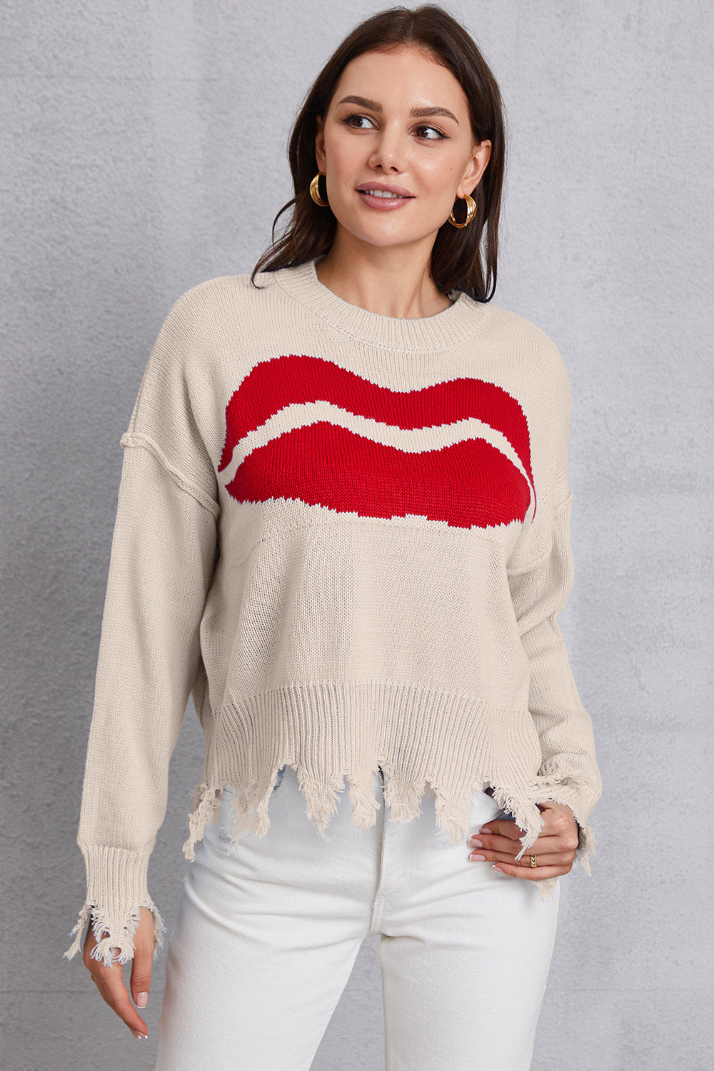 Cream knit sweater with red kiss graphic, distressed hem and cuffs.