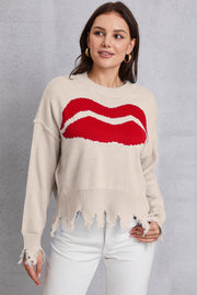 Cream knit sweater with red kiss graphic, distressed hem and cuffs.