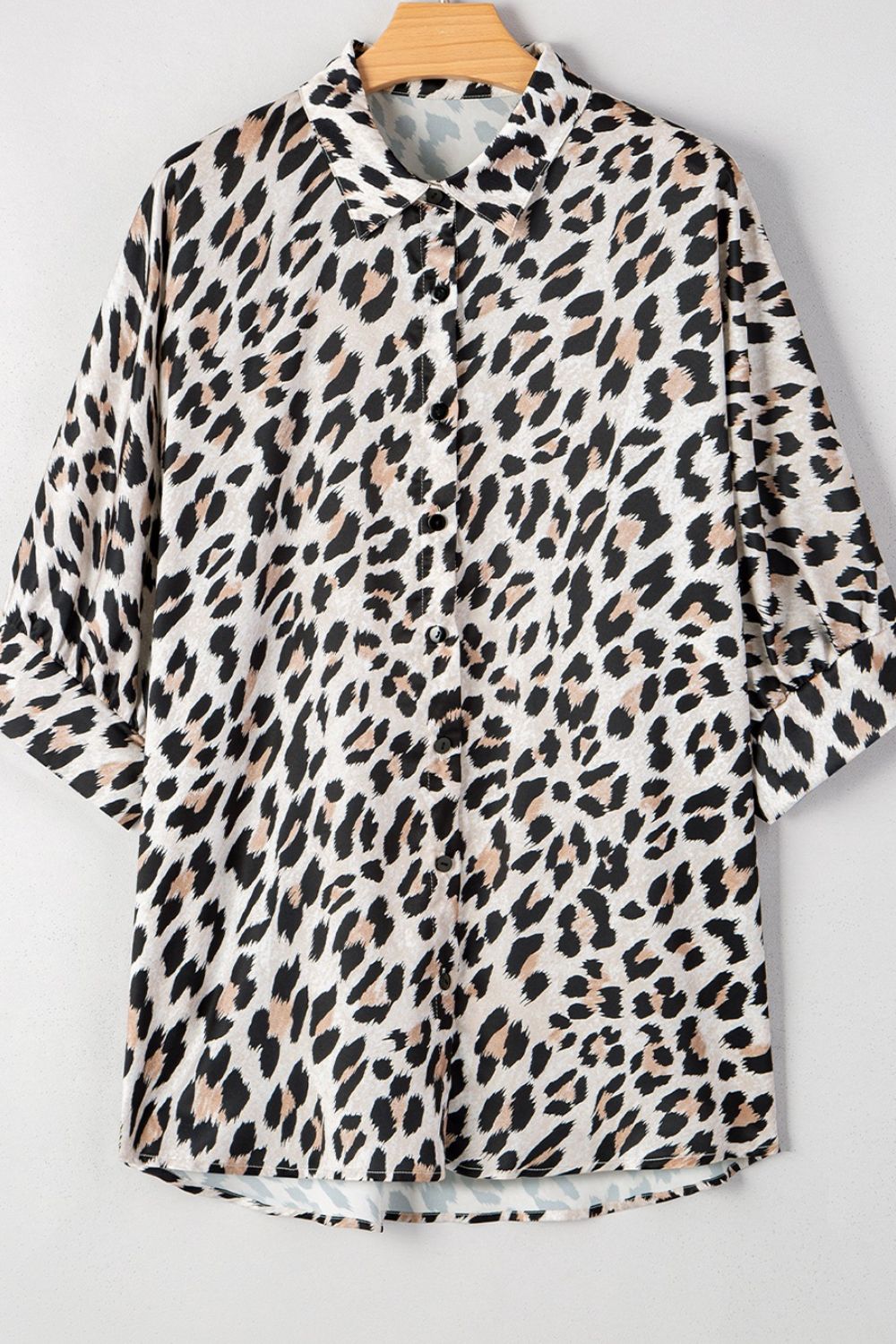 Leopard print oversized button-down blouse with 3/4 sleeves.