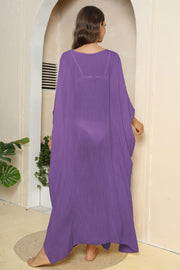 Purple oversized caftan cover-up with side slits, sheer fabric, v-neck, long flowy sleeves.