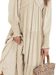 Apricot smocked v-neck tiered maxi dress with ruffled details and smocked cuffs.