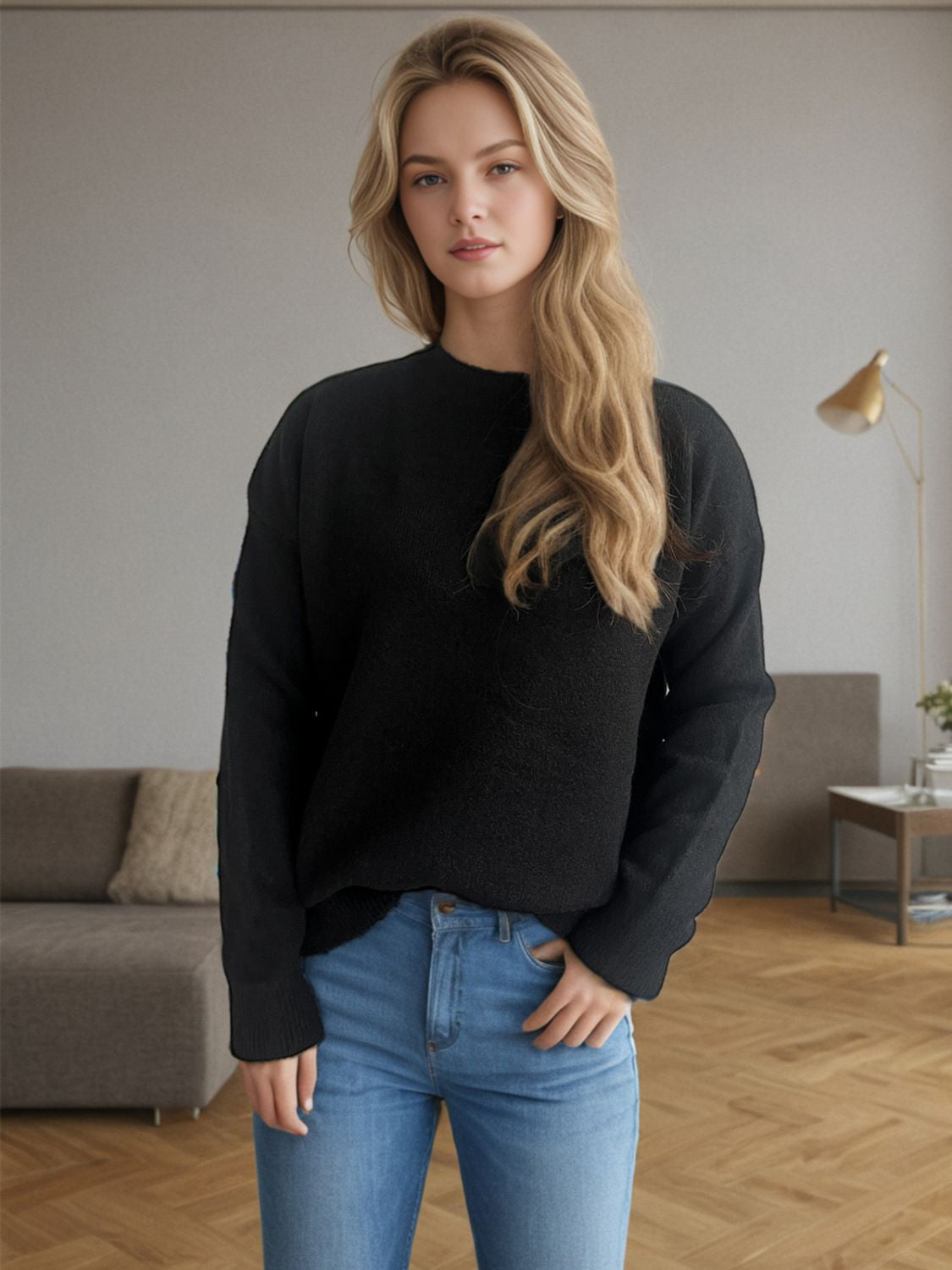 Black textured knit crew neck pullover sweater with long sleeves.