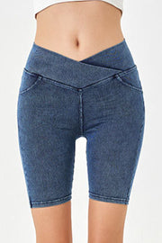 Denim bermuda shorts in medium blue with a crisscross waistband and faux pockets.