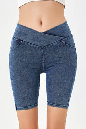Denim bermuda shorts in medium blue with a crisscross waistband and faux pockets.