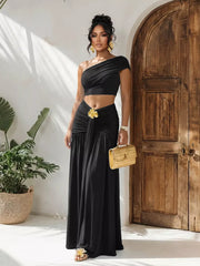 Black one-shoulder ruched crop top and maxi skirt set with gold flower detail