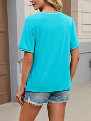 Blue-green t-shirt with short sleeves and contrast trim on neckline and cuffs.