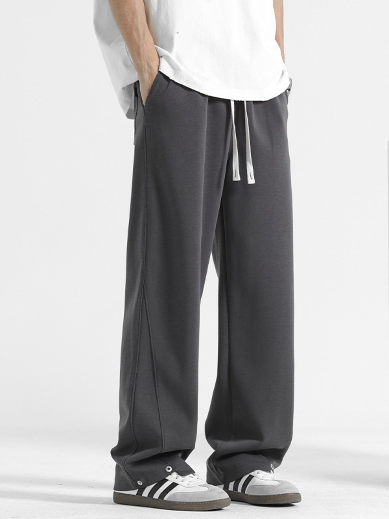 Men's dark gray sweatpants with drawstring and side seam detail.