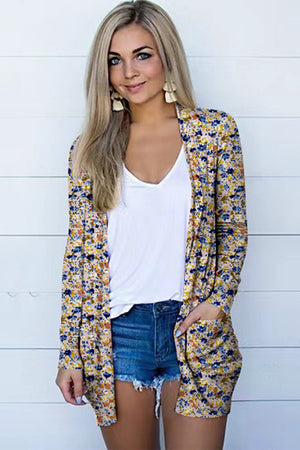 Floral print open-front duster cardigan with pockets, styled with a white v-neck top and denim shorts.