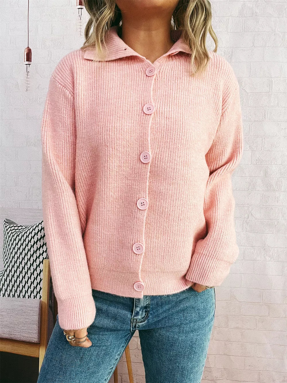 Pink ribbed button-up cardigan with polo collar and matching buttons.