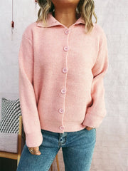 Pink ribbed button-up cardigan with polo collar and matching buttons.