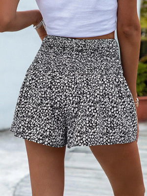 Black floral chino shorts with elastic waist and ruffled hem