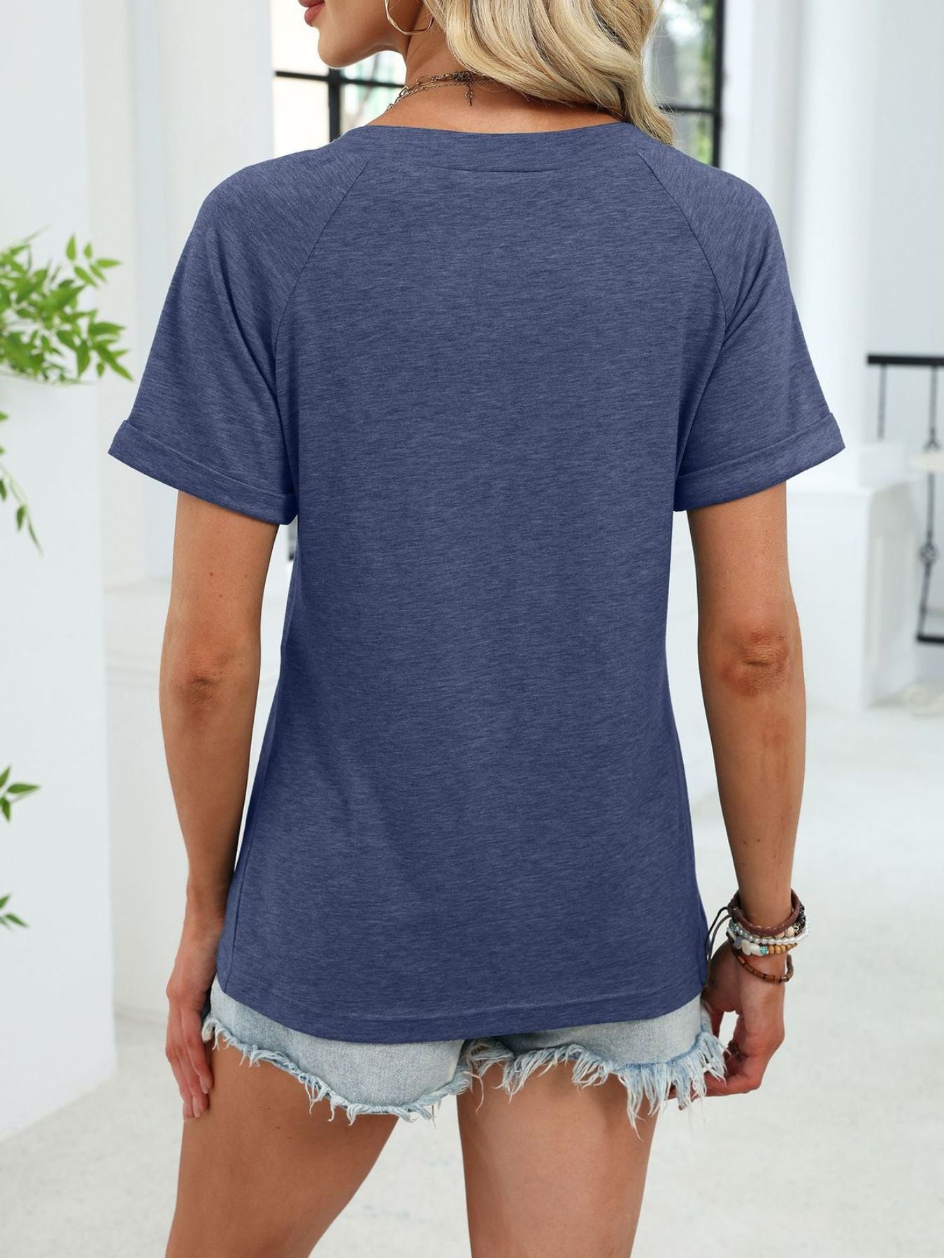 Navy blue short sleeve t-shirt with ruched V-neck and cuffed sleeves.