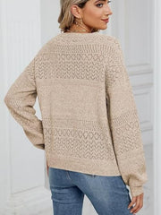 Tan eyelet stitch v-neck pullover sweater with long sleeves.