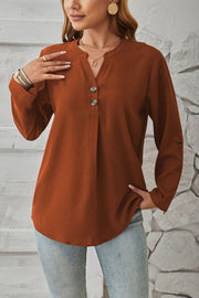 Rust V-neck button-down blouse with cuffed sleeves and a relaxed fit.