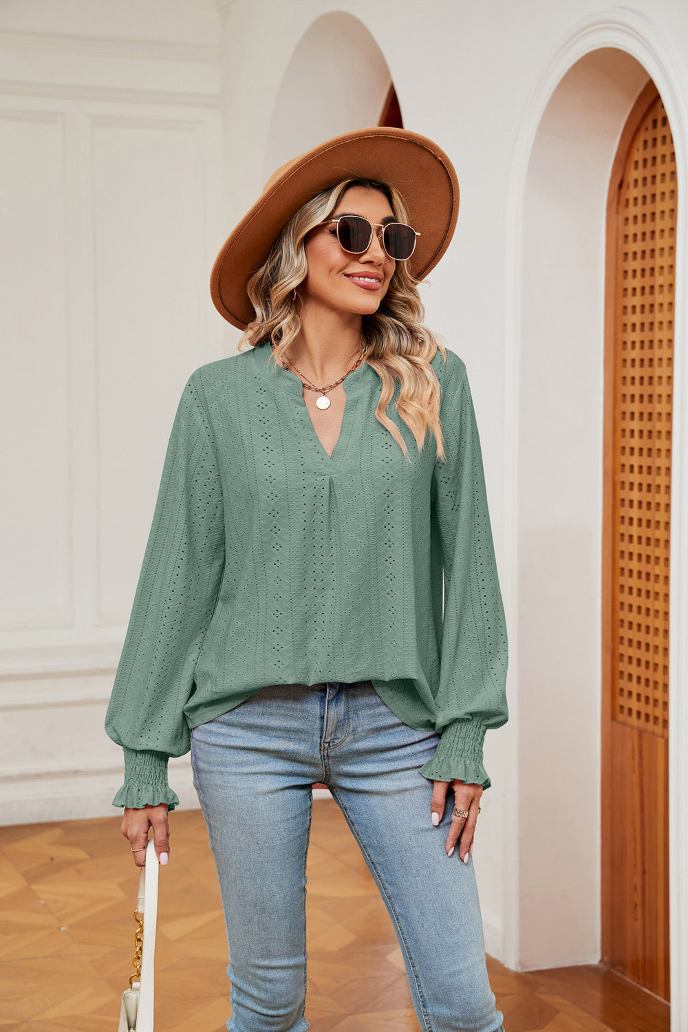 Gum Leaf eyelet detail poet sleeve blouse with V-neck and smocked cuffs.