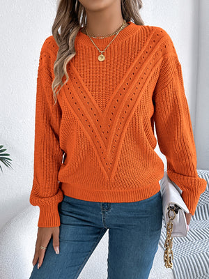 Orange chevron knit sweater with eyelet detail, crew neck, and long sleeves.