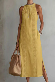 Elegant midi dress in gold with lace trim and pockets, sleeveless with a high neckline.